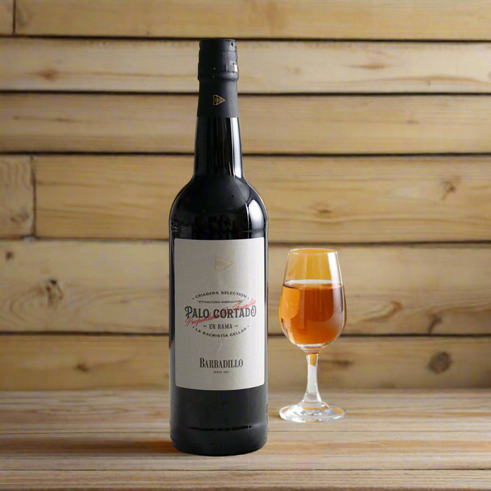 Wine bottle with a glass of wine on a yellow background